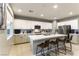 Well-lit kitchen featuring an island with seating, stainless steel appliances, and modern cabinetry with a clean design at 10372 Thurso Ave, Las Vegas, NV 89166