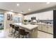 Open kitchen with a spacious island, modern appliances, and a view to the outdoor patio through a sliding glass door at 10372 Thurso Ave, Las Vegas, NV 89166