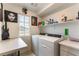 Functional laundry room equipped with washer, dryer, and storage shelves at 10372 Thurso Ave, Las Vegas, NV 89166
