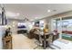 Open-concept living and dining area with modern decor and access to outdoor patio at 10372 Thurso Ave, Las Vegas, NV 89166