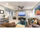 Bright living room featuring tile flooring, comfortable seating, and a ceiling fan at 10372 Thurso Ave, Las Vegas, NV 89166