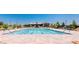 Skye Canyon community swimming pool surrounded by lounge chairs and greenery at 10372 Thurso Ave, Las Vegas, NV 89166