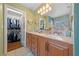 Bathroom featuring double sinks, granite counters and a walk-in closet at 10440 Bay Ginger Ln, Las Vegas, NV 89135