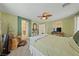 Relaxing bedroom with ceiling fan, woven chair, and large windows at 10440 Bay Ginger Ln, Las Vegas, NV 89135