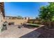 Private backyard with a charming patio, artificial grass, and desert landscaping at 105 Pollentia Ave, North Las Vegas, NV 89084