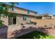 Beautiful backyard with patio, artificial grass, mature tree and privacy wall at 105 Pollentia Ave, North Las Vegas, NV 89084