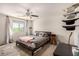 Cozy bedroom featuring a ceiling fan, window with natural light, and unique cowboy hat decor at 105 Pollentia Ave, North Las Vegas, NV 89084