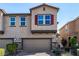 Charming two-story townhome featuring a two-car garage and stone accents at 105 Pollentia Ave, North Las Vegas, NV 89084