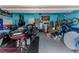 Spacious garage featuring a motorcycle, storage, and epoxy flooring at 105 Pollentia Ave, North Las Vegas, NV 89084