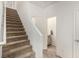 Hallway with carpeted stairs and half bathroom at 105 Pollentia Ave, North Las Vegas, NV 89084