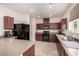 Modern kitchen featuring wood cabinets, stainless steel appliances, and a tile floor at 105 Pollentia Ave, North Las Vegas, NV 89084