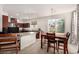 Open kitchen and dining area with wood cabinets, an island, and stainless appliances at 105 Pollentia Ave, North Las Vegas, NV 89084
