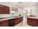 Bright kitchen featuring wood cabinets, stone countertops, and stainless appliances at 105 Pollentia Ave, North Las Vegas, NV 89084