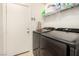 Functional laundry room with shelving, modern washer, and dryer at 105 Pollentia Ave, North Las Vegas, NV 89084