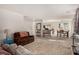 Open-concept living area with carpet, dining space, and lots of natural light at 105 Pollentia Ave, North Las Vegas, NV 89084