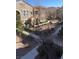 View of the community from the balcony, showcasing sidewalks, landscaping, and building architecture at 10550 W Alexander Rd # 2183, Las Vegas, NV 89129