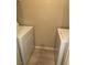 Bright laundry area featuring a white, side-by-side washer and dryer set on light-colored flooring at 10550 W Alexander Rd # 2183, Las Vegas, NV 89129