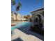 Resort-style pool area features lounge chairs, palm trees, and a covered seating area at 10550 W Alexander Rd # 2183, Las Vegas, NV 89129