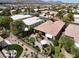 Aerial view of the backyard showcasing the outdoor living area, lush landscaping, and desert surroundings at 10581 Santo Marco Ct, Las Vegas, NV 89135