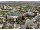 Aerial view of a luxurious community center with a lake, golf course, and meticulously landscaped grounds at 10581 Santo Marco Ct, Las Vegas, NV 89135