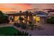 Inviting backyard with covered patio, desert landscaping, and a warm sunset backdrop at 10581 Santo Marco Ct, Las Vegas, NV 89135