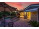 Inviting backyard featuring covered patio, mature palms, seating, and desert landscaping at 10581 Santo Marco Ct, Las Vegas, NV 89135