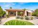 Inviting backyard with covered patio, vibrant plants, and artificial grass at 10581 Santo Marco Ct, Las Vegas, NV 89135