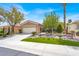 Charming single-story home featuring manicured landscaping, mature trees, and a two-car garage at 10581 Santo Marco Ct, Las Vegas, NV 89135