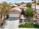 Charming single-story home featuring manicured landscaping, mature trees, and a two-car garage at 10581 Santo Marco Ct, Las Vegas, NV 89135