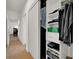 Hallway closet with custom shelves to provide storage, and is located near a room with wood floors at 10581 Santo Marco Ct, Las Vegas, NV 89135