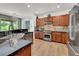 The kitchen is equipped with stainless steel appliances, granite counters, and plenty of wood cabinet space at 10581 Santo Marco Ct, Las Vegas, NV 89135