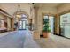 An interior lobby area with neutral wall colors, columns, large hanging lights, and entrances to various establishments at 10581 Santo Marco Ct, Las Vegas, NV 89135