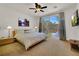 Comfortable main bedroom featuring neutral decor and large windows that provide backyard view at 10581 Santo Marco Ct, Las Vegas, NV 89135