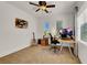 Well-lit office featuring a guitar, large windows, a ceiling fan, and carpet flooring at 10581 Santo Marco Ct, Las Vegas, NV 89135