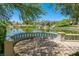 An outdoor patio area overlooking a pond with desert vegetation and blue skies in the background at 10581 Santo Marco Ct, Las Vegas, NV 89135