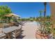 A patio area with a pool and lounge chairs in a desert landscape and clear blue skies at 10581 Santo Marco Ct, Las Vegas, NV 89135