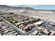 Wide aerial view shows a desert community surrounded by open spaces with mountain views at 10624 Tuckermans Ave, Las Vegas, NV 89129