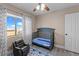 Comfortable bedroom with a crib and chair at 10624 Tuckermans Ave, Las Vegas, NV 89129