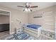 Bedroom with a ceiling fan, single bed, and shelves at 10624 Tuckermans Ave, Las Vegas, NV 89129