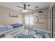 A bedroom features a ceiling fan, single bed, and shelves at 10624 Tuckermans Ave, Las Vegas, NV 89129