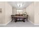 Formal dining area featuring an elegant table set with seating for six and modern chandelier at 10624 Tuckermans Ave, Las Vegas, NV 89129