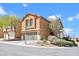 Inviting two-story home featuring a two-car garage and manicured desert landscaping, perfect for curb appeal at 10624 Tuckermans Ave, Las Vegas, NV 89129