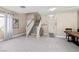 Inviting foyer with staircase, gray floors, and neutral tones, leading to the upper level at 10624 Tuckermans Ave, Las Vegas, NV 89129
