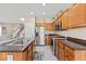 Open kitchen layout with stainless appliances, dark countertops, and center island with a sink at 10624 Tuckermans Ave, Las Vegas, NV 89129