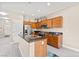 Well-lit kitchen featuring stainless steel appliances, wooden cabinetry and island for meal prep at 10624 Tuckermans Ave, Las Vegas, NV 89129