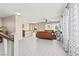 Bright, open-concept living room with hardwood floors, modern furniture, and large windows for natural light at 10624 Tuckermans Ave, Las Vegas, NV 89129