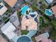 Aerial view of a home with a solar panel roof, beautiful landscaping, pool, putting green, and surrounding neighborhood at 11037 Clarion Ln, Las Vegas, NV 89134