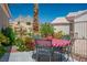 Outdoor patio featuring a table and chairs, with lush landscaping and mountain views at 11037 Clarion Ln, Las Vegas, NV 89134