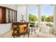 Charming bar area featuring custom wood cabinetry, stool seating and picturesque outdoor views at 11037 Clarion Ln, Las Vegas, NV 89134