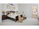 Bright bedroom featuring a wooden bed frame, stylish decor, and an ensuite bathroom, creating a relaxing retreat at 11037 Clarion Ln, Las Vegas, NV 89134